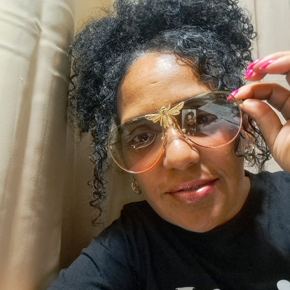 Unixex glasses. black and pink tinted glass. with gold edges and bee logo